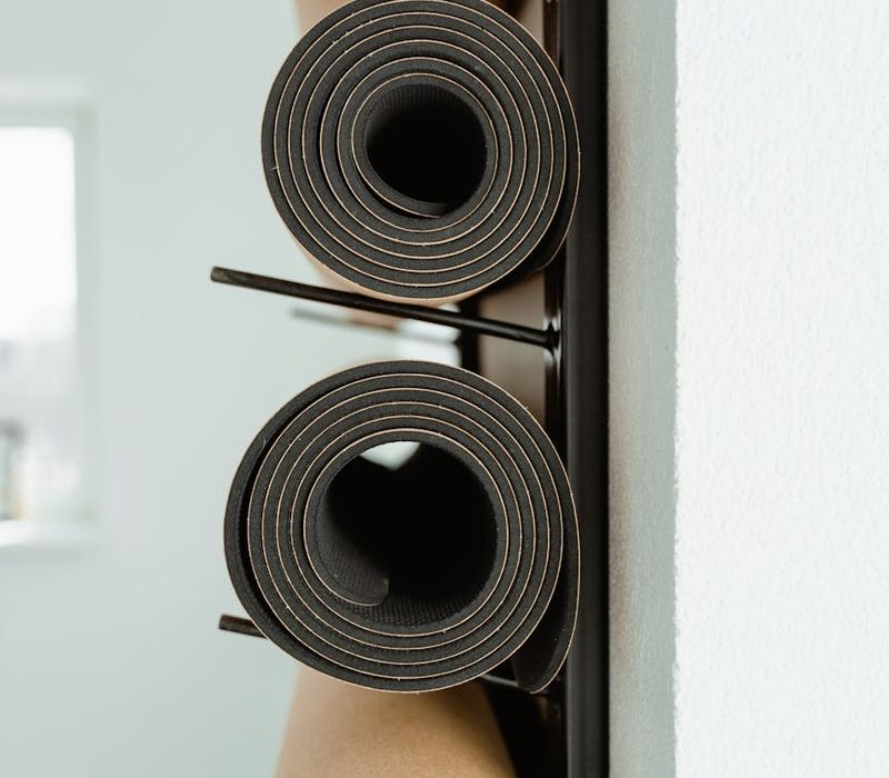 Couple packing their yoga mats into a bag, preparing for a class.
