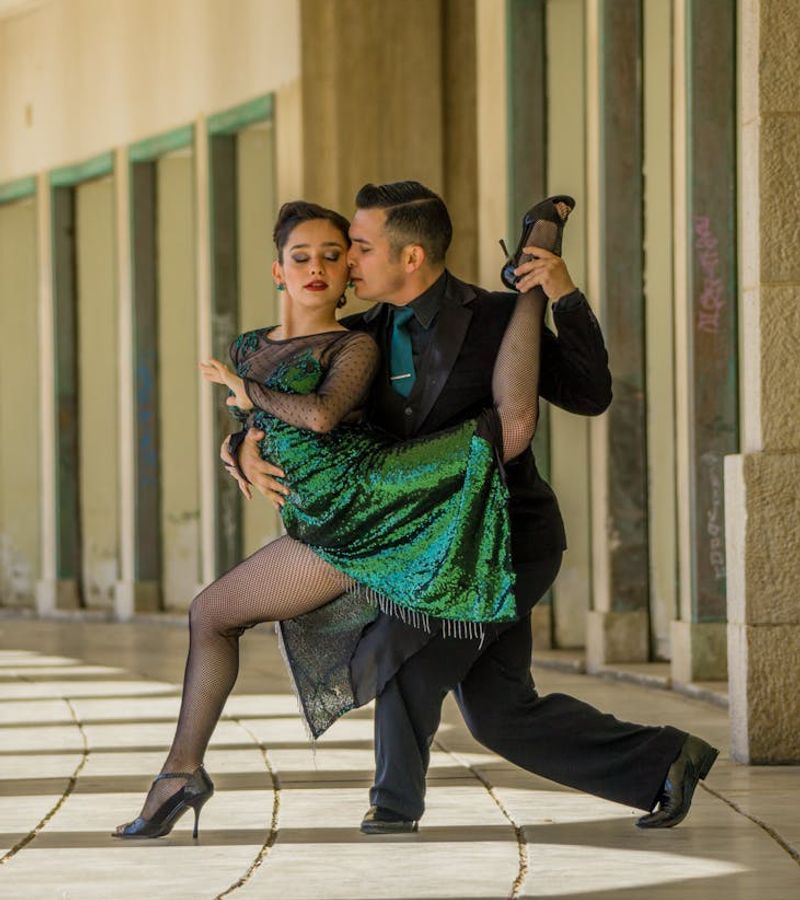 Couple performing a synchronized partner yoga pose in a tranquil setting.